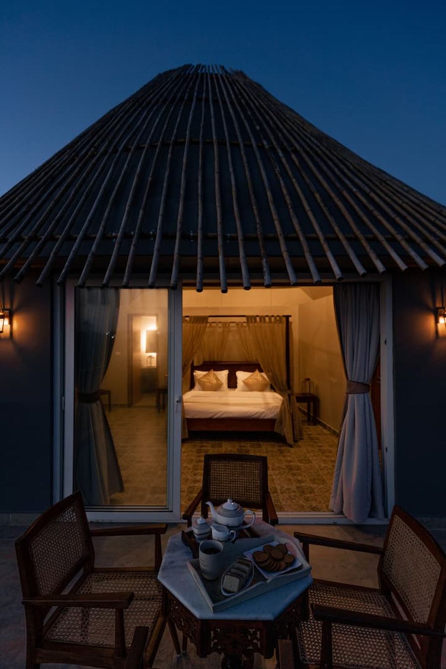 Bamboo roof bedroom through glass at night
