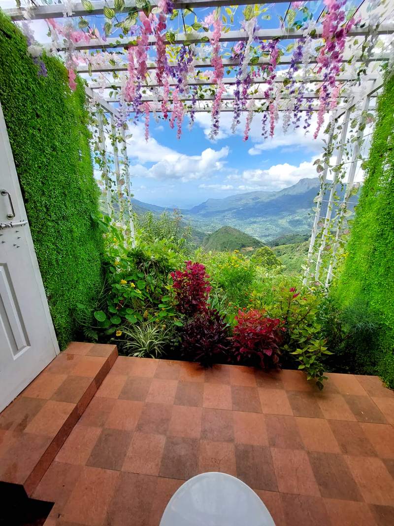 Flower-draped outdoor bathroom valley view