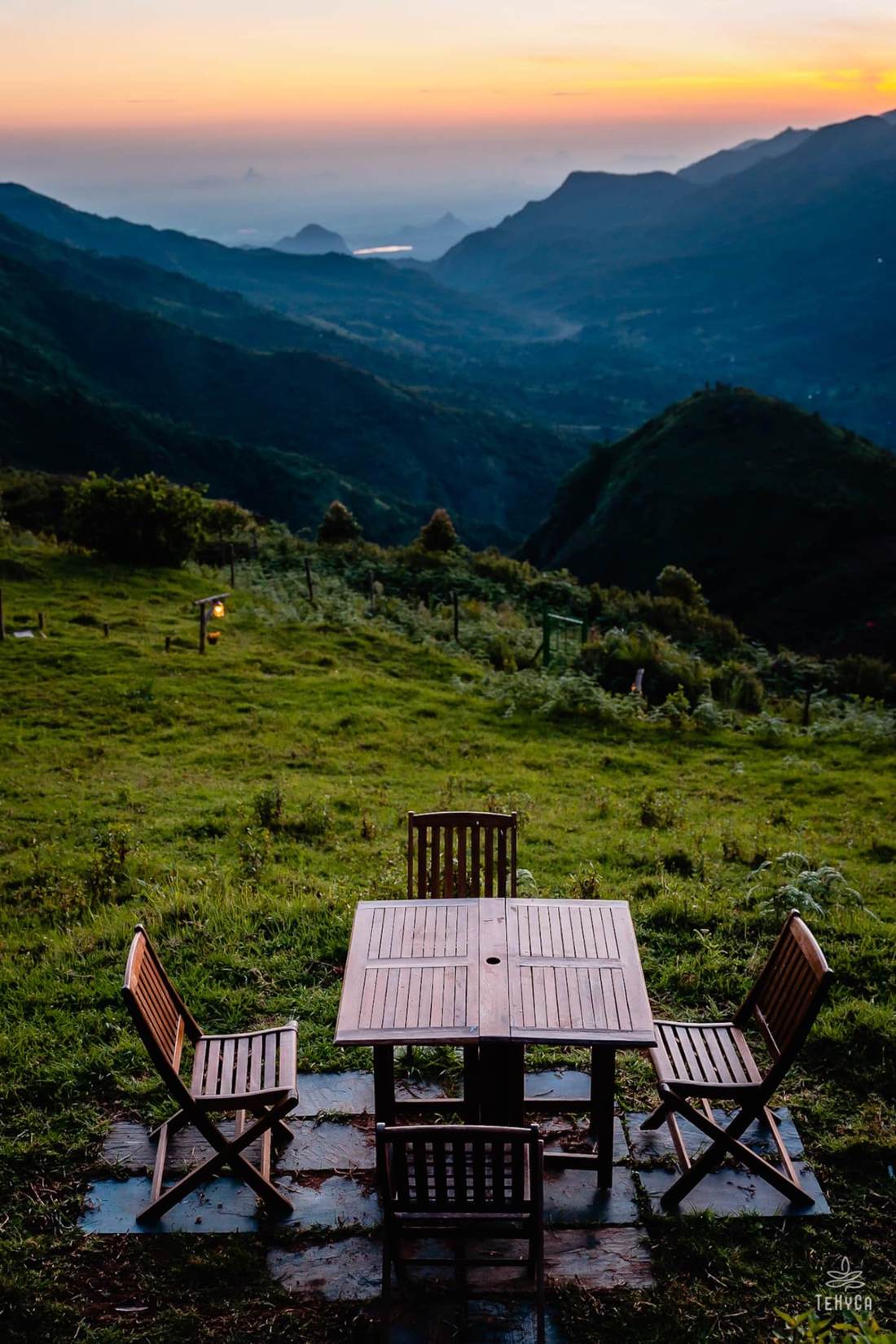 Tehyca — dinner table facing layered blue mountain sunset