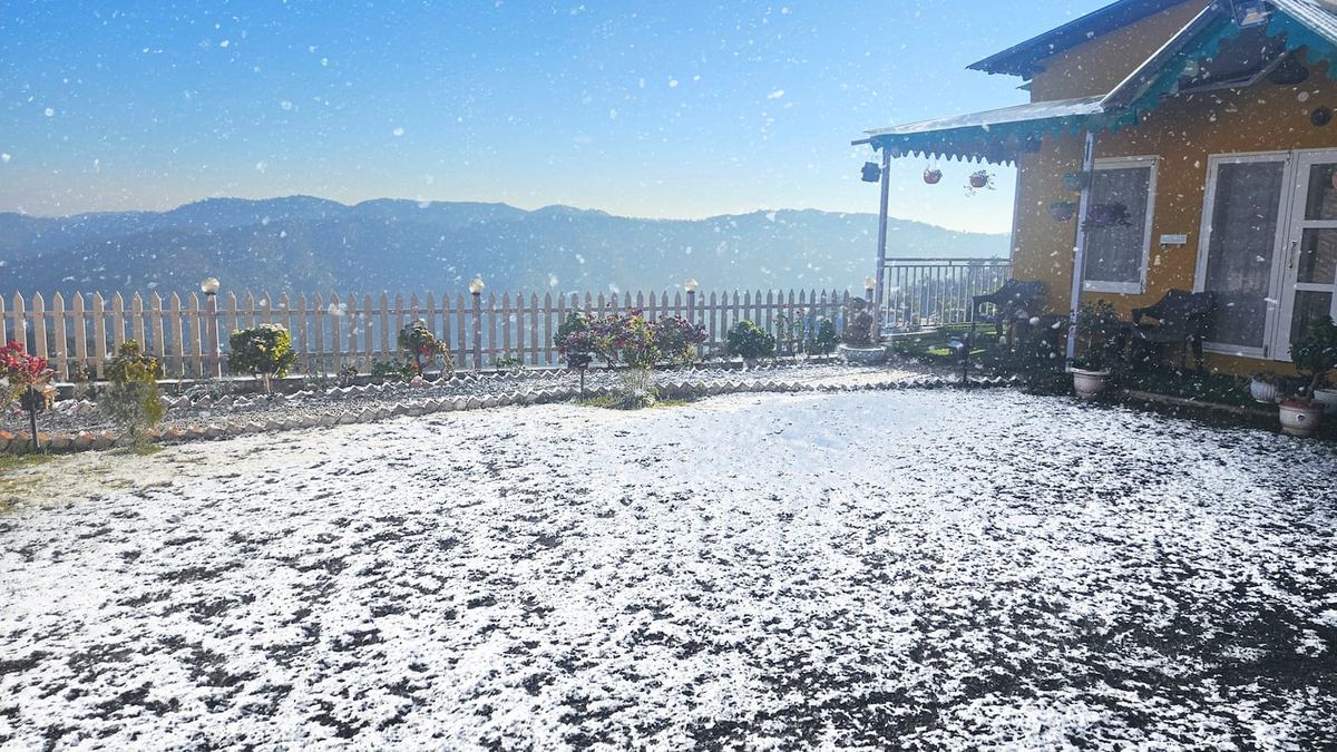 Villa Kailasa — snowfall on the garden with Himalayan peaks behind
