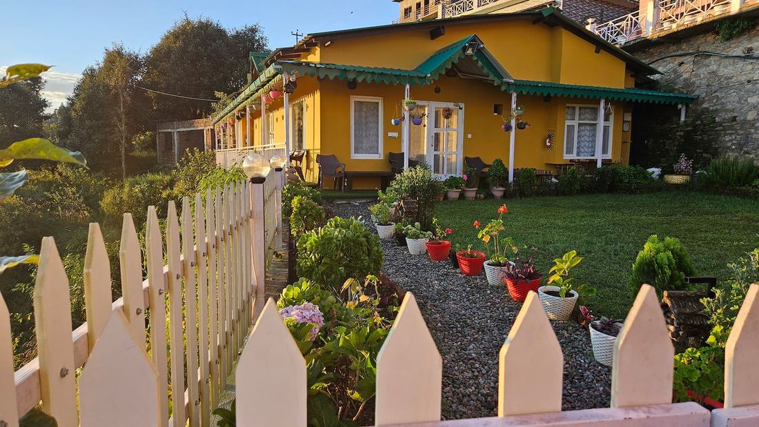 Villa Kailasa — yellow cottage at golden hour