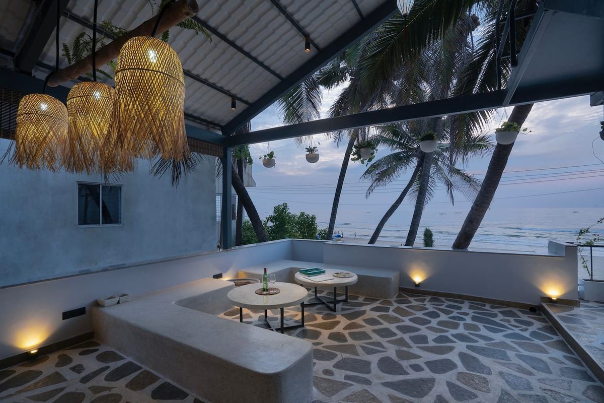 Sea Gadabout — bamboo lantern sunken lounge at dusk with sea